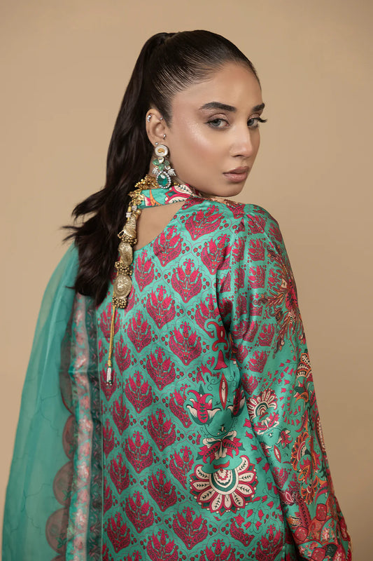 Model wearing Farah K Sea Jasmin soft green formal suit with floral embroidery.